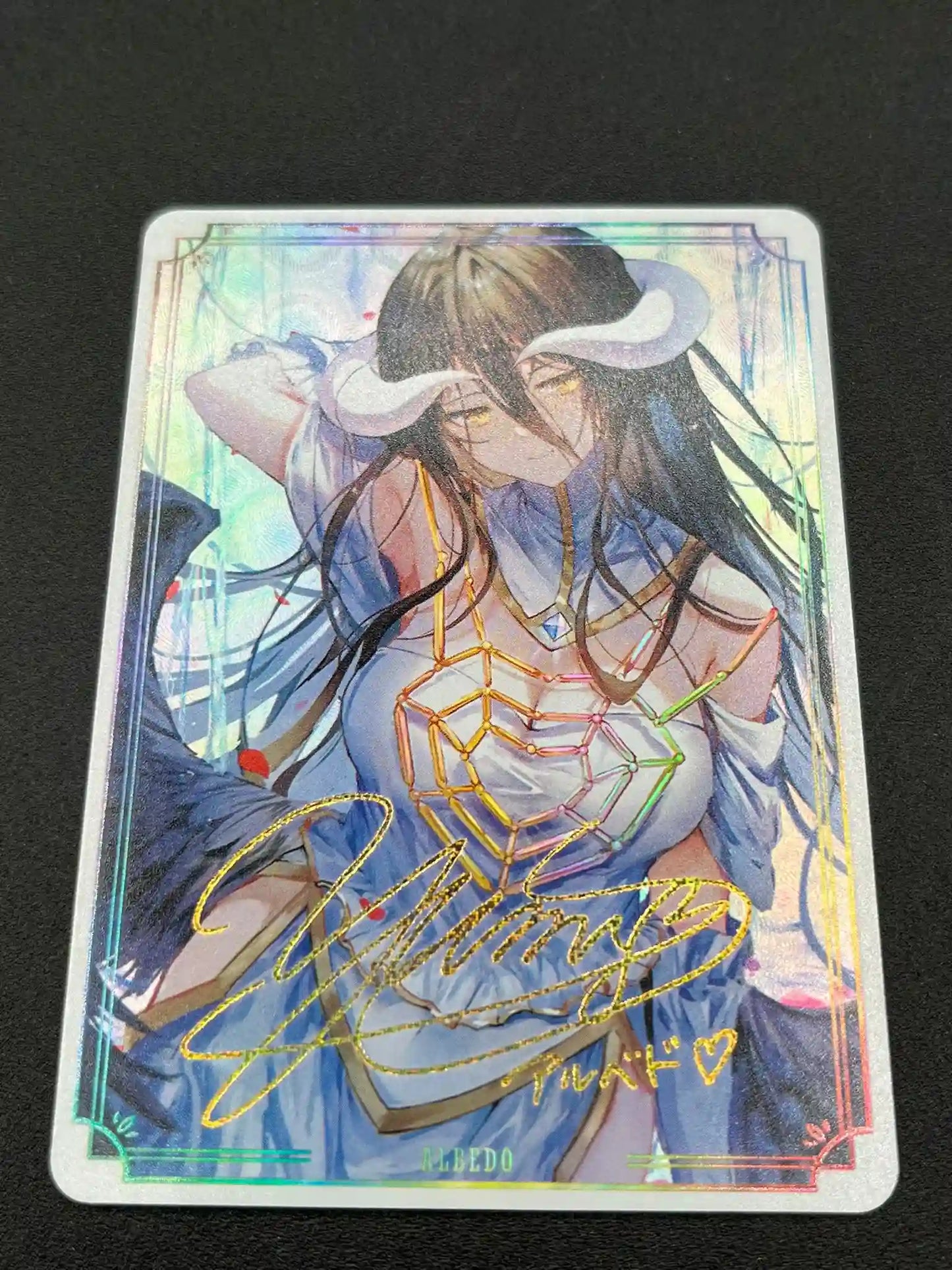 Close-up of Albedo Overlord Waifu Card showing signature and holographic effects