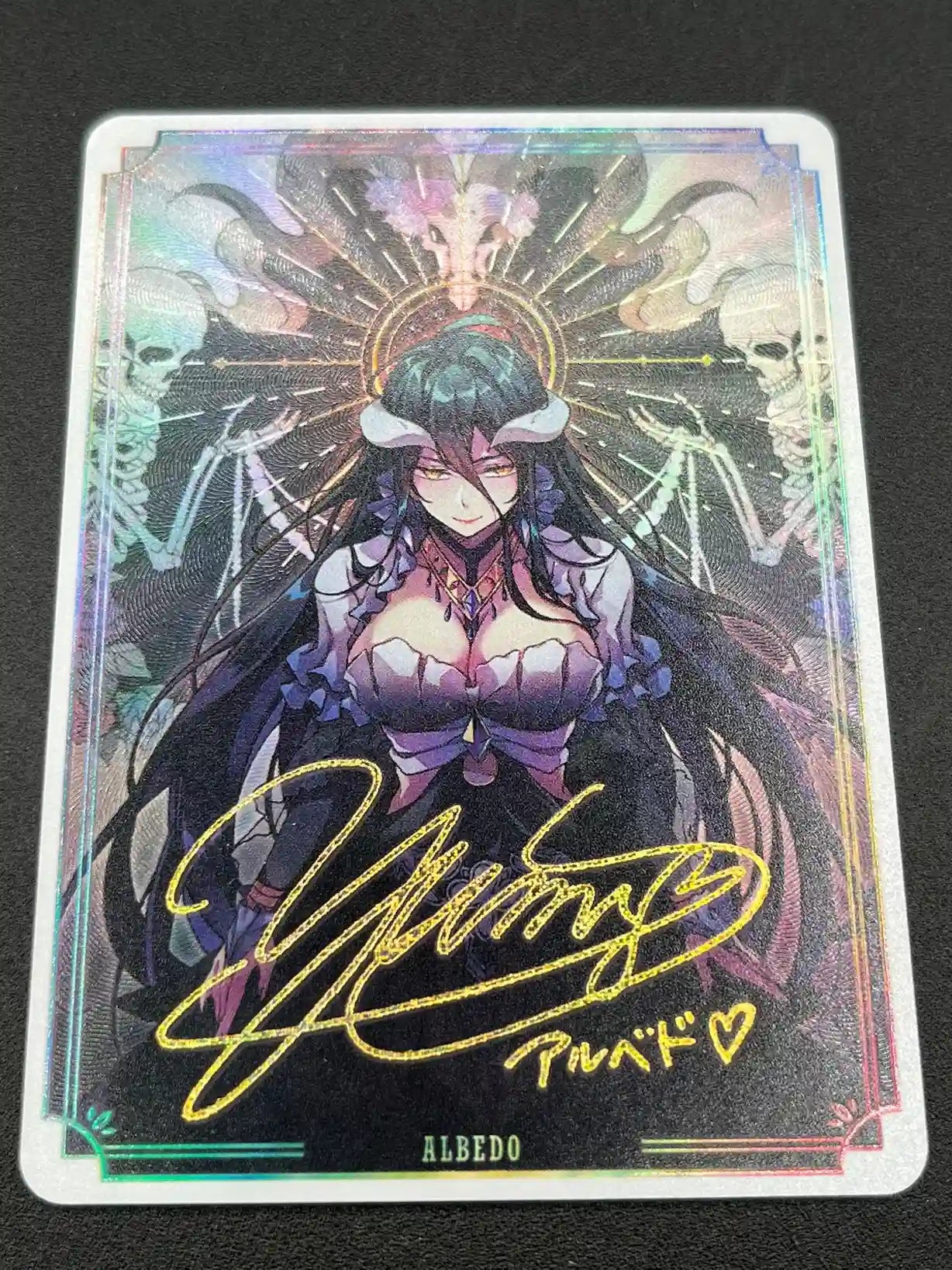 Close-up detail of artwork and gold foil signature on Albedo Overlord Waifu Collector Card