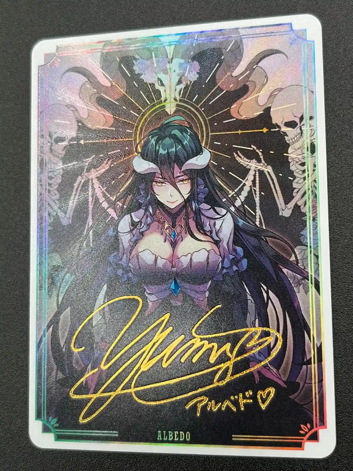 Close-up of Albedo Overlord Waifu Collector Card showing signature and texture details