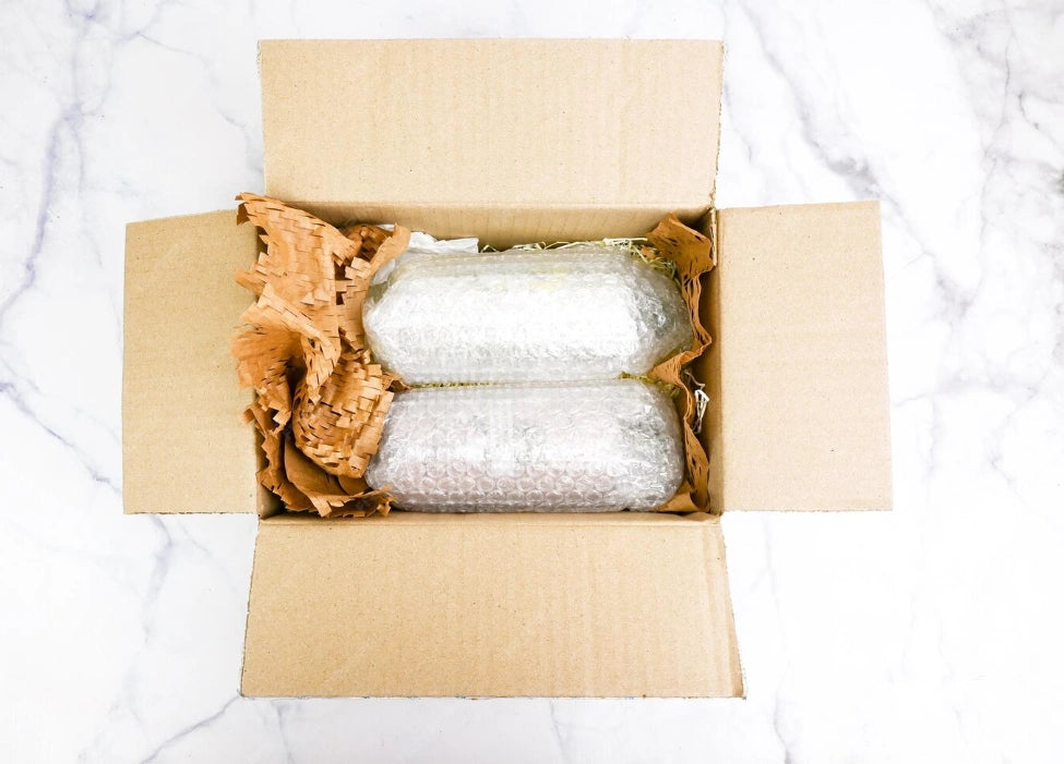 Demonstration of Choco Vault’s reinforced package protection using bubble wrap and paper padding